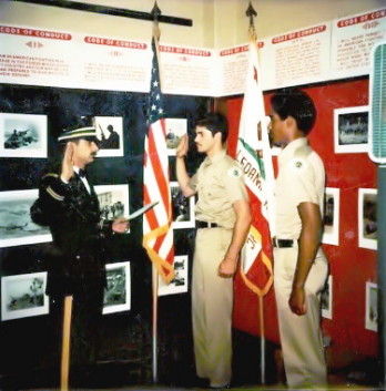 LT Michael A. LePeilbet giving the oath of office to two new soldiers enlisting in the National Guard