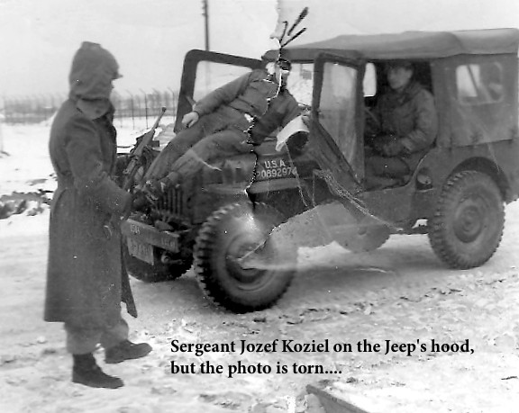 SGT Koziel on the front of a Jeep