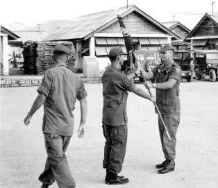 On 15 February 1966 before assembled elements of all units of the 14th Aviation Battalion, Lt Col Joseph P. Smith relinquished the Battalion colors to Major Ronald J. Rogers. In a following ceremony (L to R) Maj. Paul Walker, Maj. Ron J. Rogers and Maj. Russ Edwards, change of command ceremony,18th Aviation Company