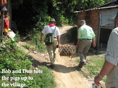Vietnam Battlefield Tours, visit to Bru Montagnard Village with a basket of five young pigs purchased at a local market