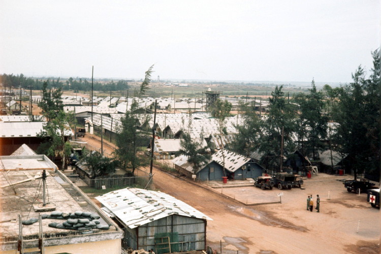 Shot take from near the control tower by Pat Snyder. In this photo, Dennis Currie and Don Ricks walked into the Med area about where the most lower right vehicle sits with a red cross on it.