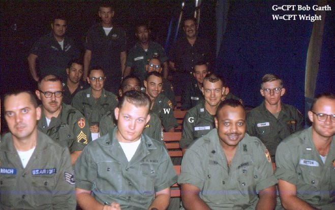 A photo by Chaplain Calvin H. Garner, probably taken during a meeting in the chapel he built at Quang Ngai in 1966. CPT Garth, 220th Avn Co., and CPT Wright are identified