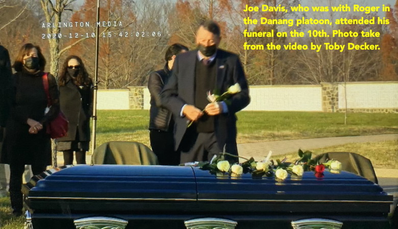 Joe Davis, Catkiller 30, placing a rose on Roger Putnam's casket