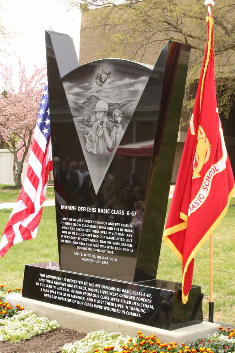 The 6-67 Memorial sits between the U.S. flag and the Marine Corps flag during the memorials dedication at The Basic School on April 25, 2014