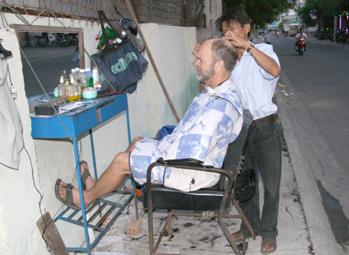 Rod Stewart getting a haircut in Vietnam
