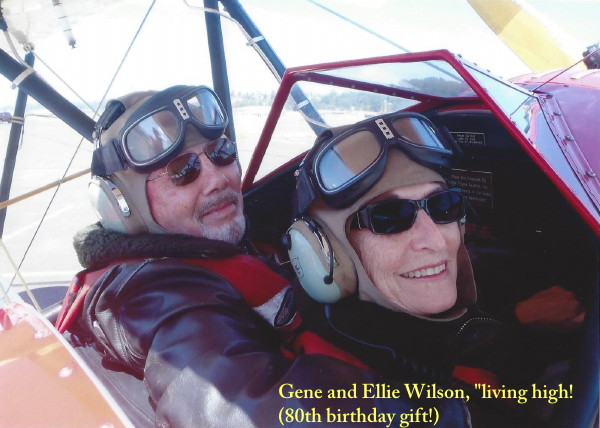 Gene and Ellie Wilson ride in a Bi-Plane