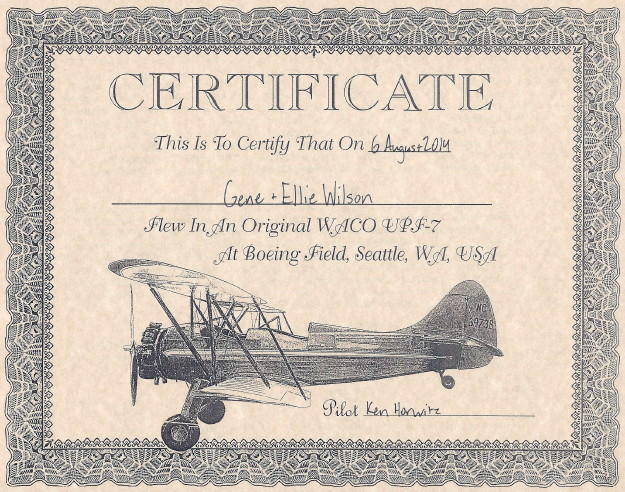 Certificate, Gene and Ellie Wilson ride in a WACO UPF-7